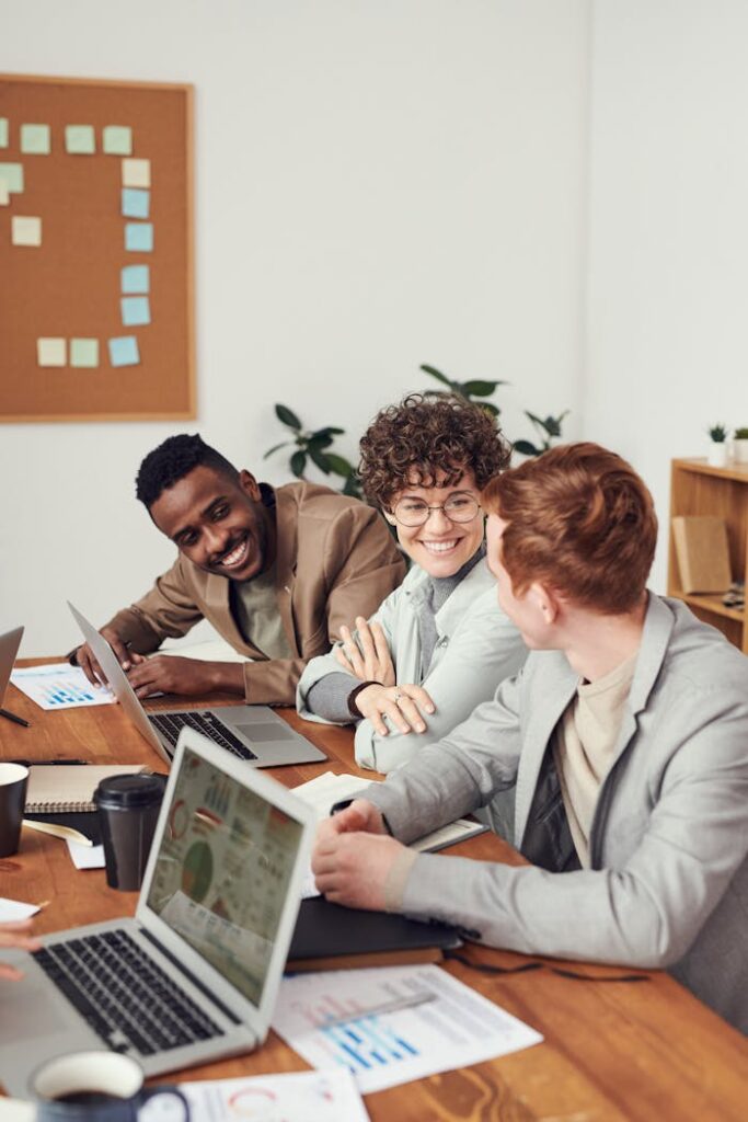 Photo Of People Leaning On Wooden Table